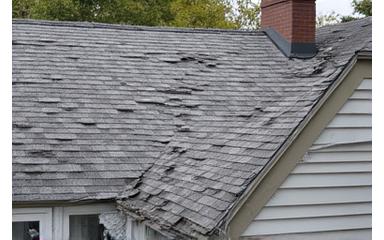 Before: Damaged roof with missing shingles